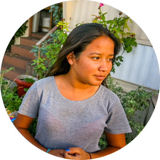 Young native american woman with home on the background
